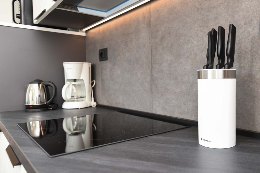 Modern kitchen hob with kettle, coffee maker and knife block near Lago di Garda
