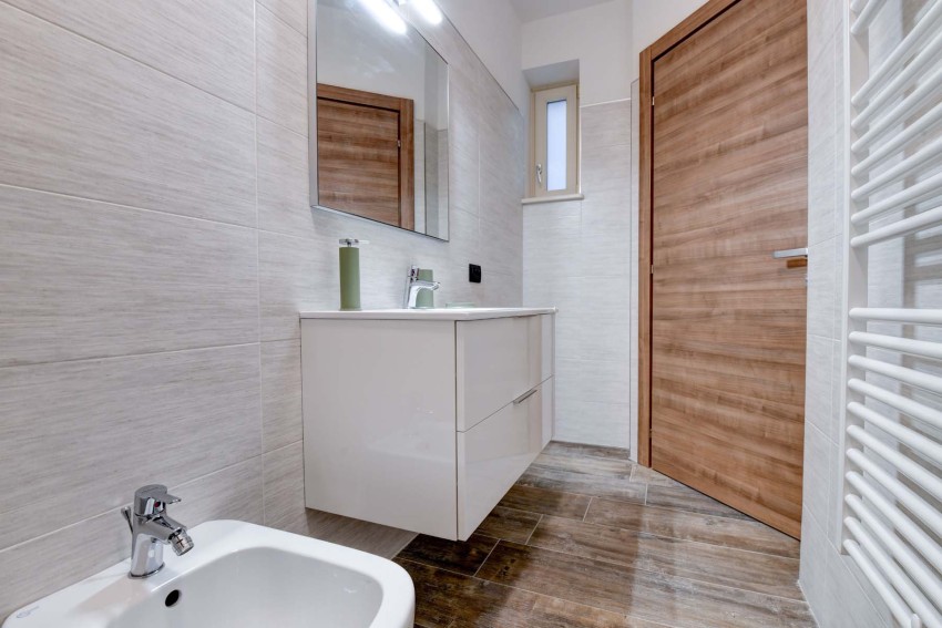 Modern bathroom with floating vanity, mirror and bidet, Lago di Garda