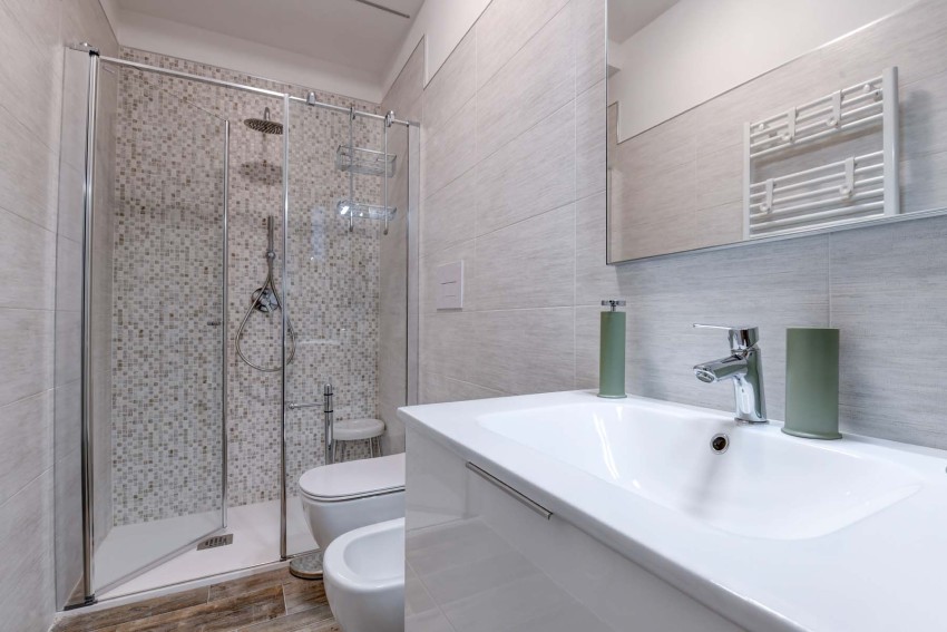 Modern bathroom with glass mosaic shower, sink and bidet at Lake Garda