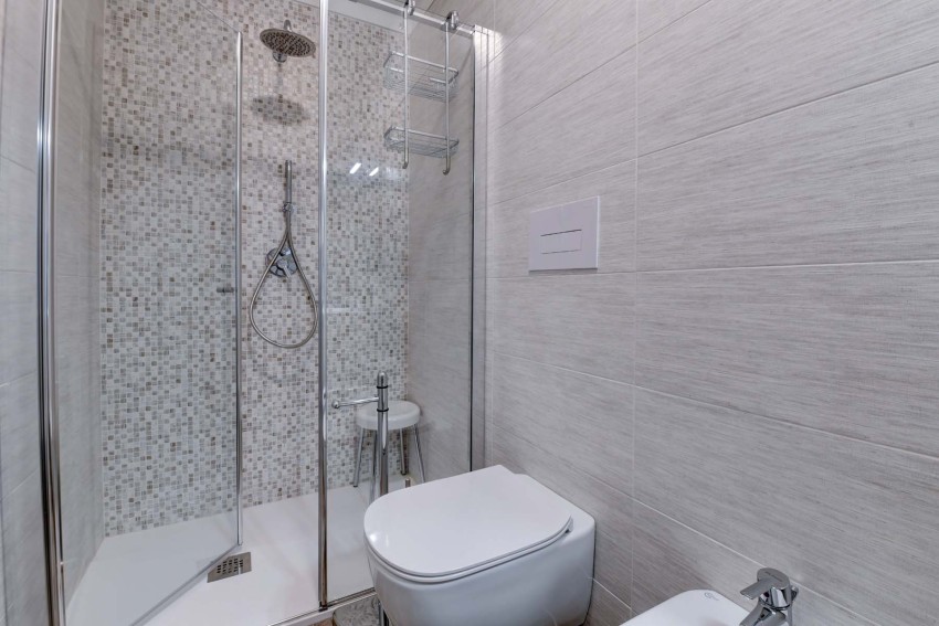 Modern bathroom with mosaic-tile shower, toilet and bidet near Lake Garda