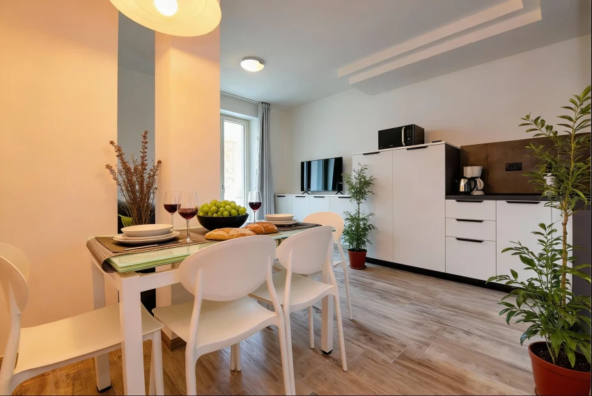 Modern kitchen-dining with wine, bread and grapes near Lake Garda.